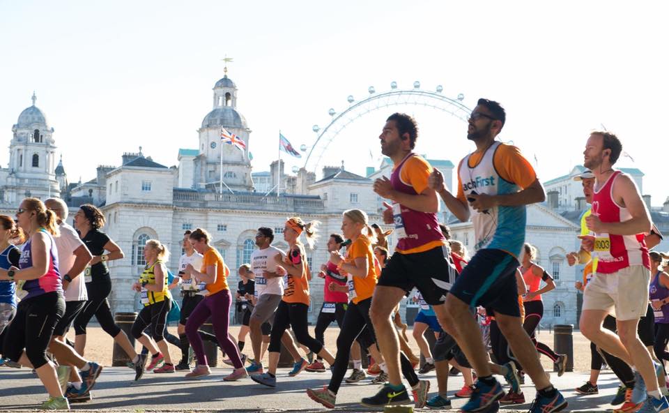 Runners running past the london eye