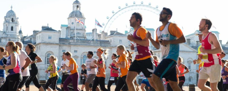 Runners running past the london eye