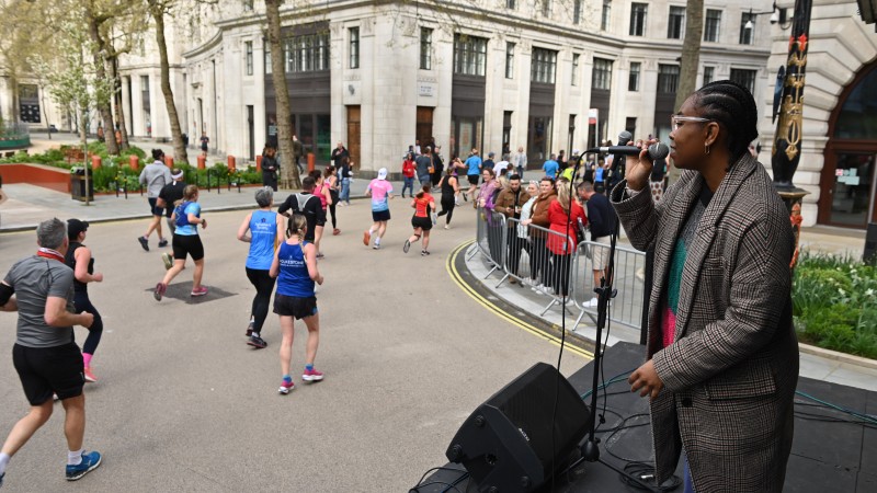 Singer performing in front of runners