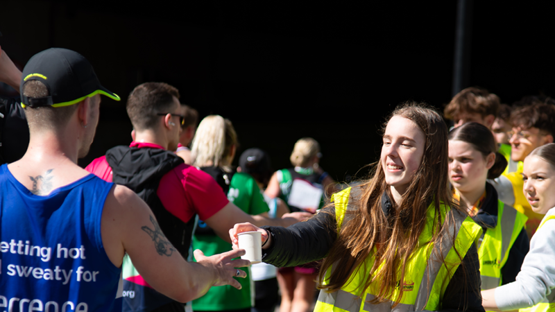Volunteer handing out water